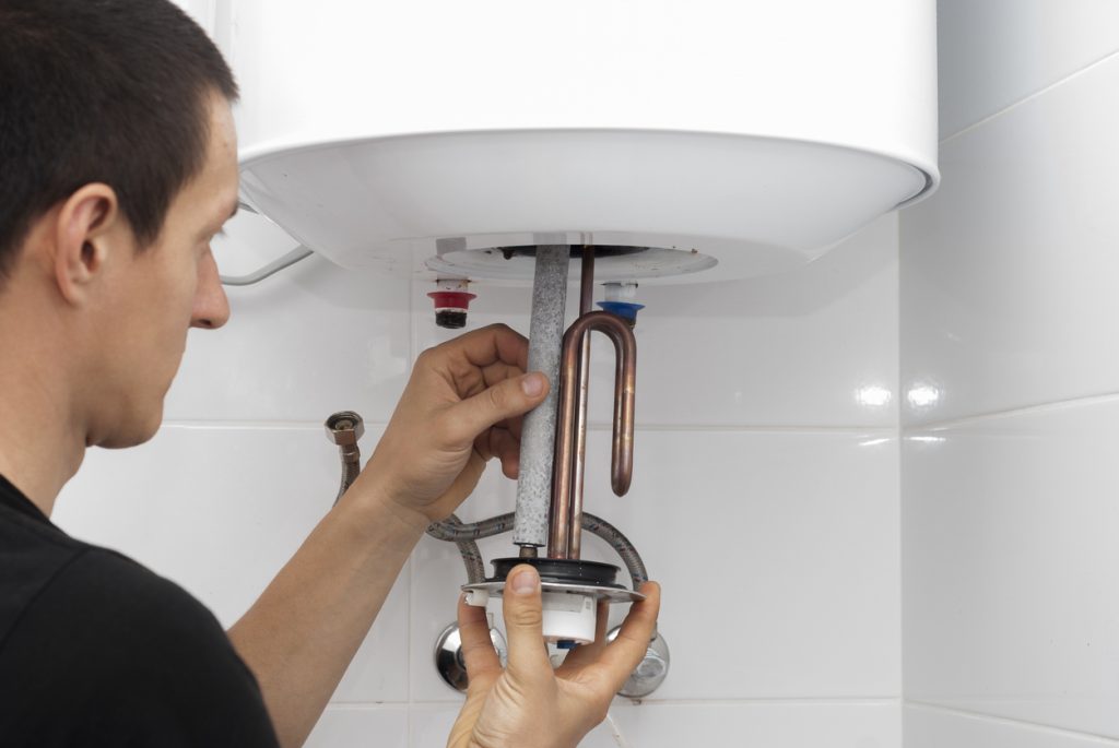 A certified plumber from Rooter MD showing the proper way to replace a water heater