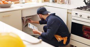 A plumber from RooterMD performing plumbing maintenance in the Spring in Livonia, MI