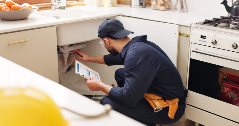 A plumber from RooterMD performing plumbing maintenance in the Spring in Livonia, MI